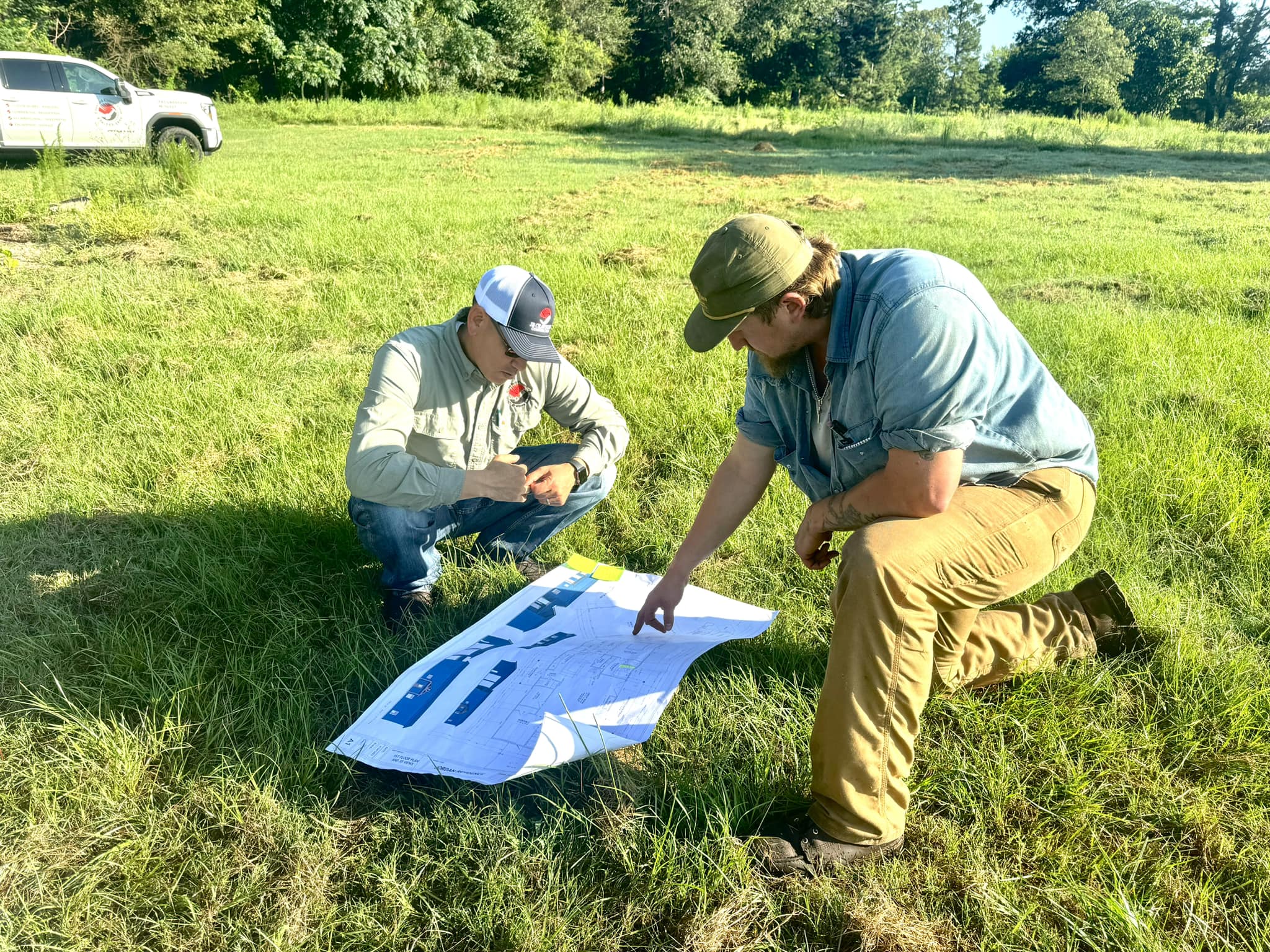 Custom home builder Jake Crawford, Owner and Operator of JB Crawford Construction, reviews house plans on homesite.