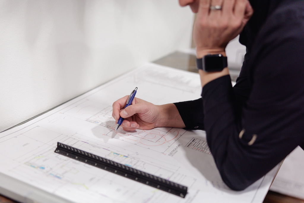 Jake Crawford, owner and operator of JB Crawford Construction, studies plan for a custom home build.