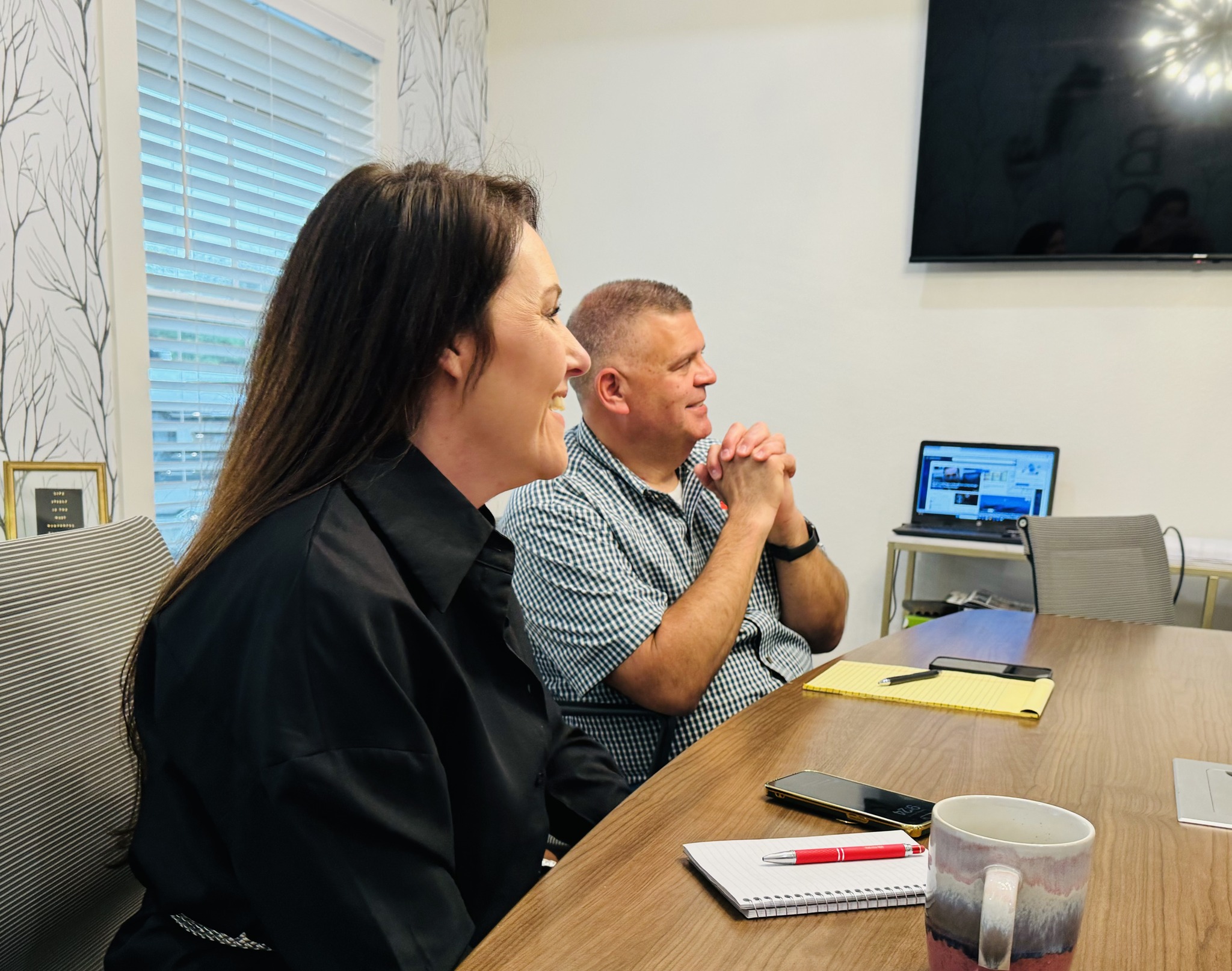 Emily Crawford, Owner and Designer of JB Crawford Construction, and General Manager Alton Hayes visit with a custom home client.
